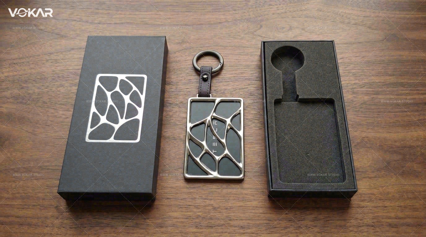Wide walnut-table unboxing of the sample lid-and-base box with a Tesla key card in the silver holder