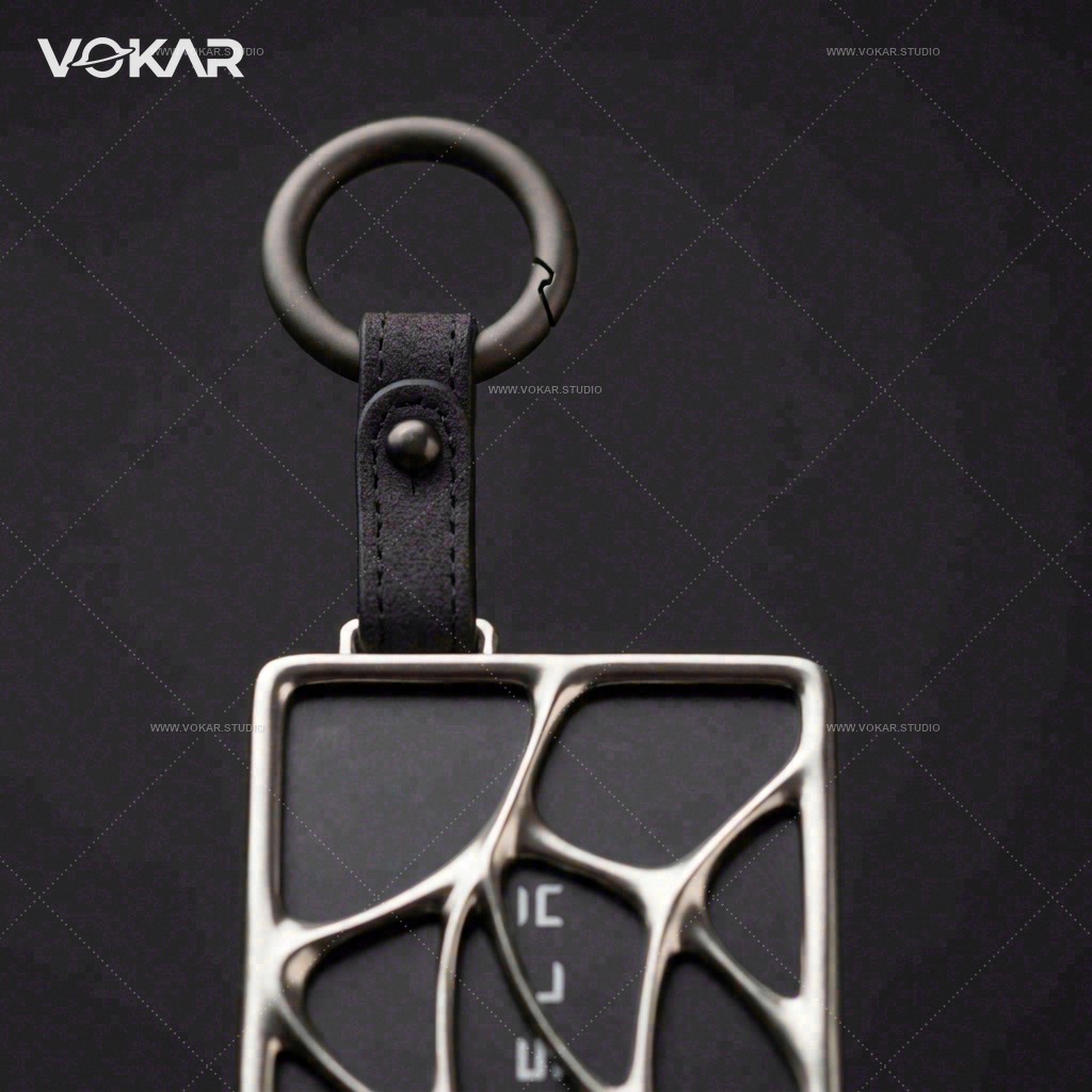 Close-up of the single-end key ring, short strap and connecting stud on the card holder