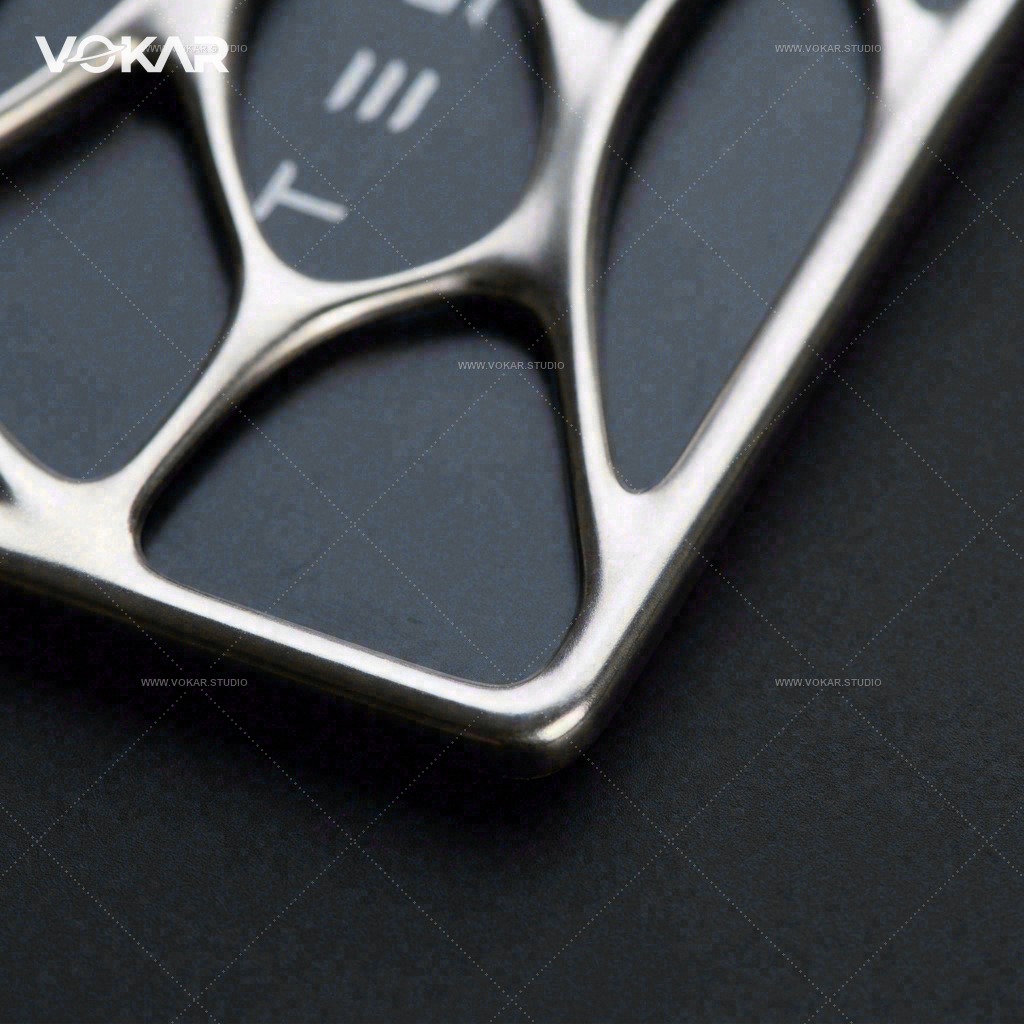 Square close-up of the black Tesla key card edge seated behind the silver frame